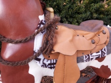 heirloom wood hand carvved rocking horse with hand made saddle and bridle, brown and white paint horse, yarn mane and tail, glass eye