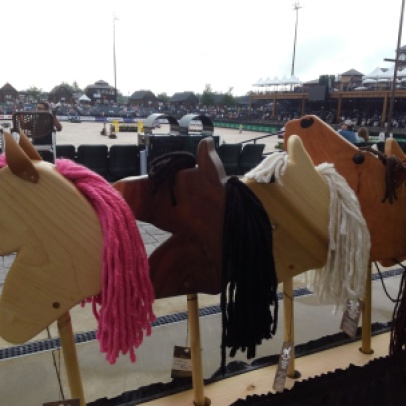 hand made hobby horses set up in front of the arena at Saturday Night Lights Tryon International Equestrian Center Gran Prix