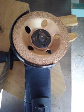 wood grinder attachment shown on blue angle grinder